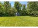 Backyard shed with ample storage and a well maintained lawn with an area for swingsets at 3105 E Banta Rd, Indianapolis, IN 46227