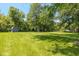 An expansive backyard with mature trees and storage shed, a nice yard to relax in and enjoy the outdoors at 3105 E Banta Rd, Indianapolis, IN 46227