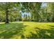 A sprawling backyard with mature trees and a storage shed, providing a perfect blend of nature and convenience at 3105 E Banta Rd, Indianapolis, IN 46227
