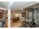 Finished basement with laminate floors, home gym, and living area with comfortable seating at 3105 E Banta Rd, Indianapolis, IN 46227