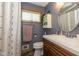 Bathroom featuring a modern vanity, stylish mirror, and a shower with updated fixtures at 3105 E Banta Rd, Indianapolis, IN 46227