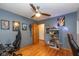 Bedroom with hardwood floors, ceiling fan and gaming setup at 3105 E Banta Rd, Indianapolis, IN 46227