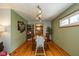 Bright dining room with hardwood floors, stylish lighting, and a view into the kitchen at 3105 E Banta Rd, Indianapolis, IN 46227