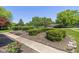 Well-maintained front yard with manicured bushes, flower bed, walkway, and green trees at 3105 E Banta Rd, Indianapolis, IN 46227