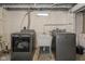 This laundry room boasts a utility sink and modern, gray Maytag washer and dryer units at 3105 E Banta Rd, Indianapolis, IN 46227