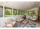 Charming screened porch with seating, string lights, and view of the backyard at 3105 E Banta Rd, Indianapolis, IN 46227