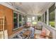Inviting screened porch with ample seating and stylish black and white patterned rug at 3105 E Banta Rd, Indianapolis, IN 46227