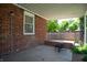 Covered back patio with brick walls, a concrete floor, and an outdoor fire pit at 3602 N Colorado Ave, Indianapolis, IN 46218