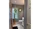 Cozy bathroom featuring a toilet, vanity, and a window with a stylish plant at 3602 N Colorado Ave, Indianapolis, IN 46218