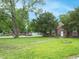 Brick home with a green lawn and mature trees in a quiet residential neighborhood at 3602 N Colorado Ave, Indianapolis, IN 46218