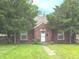 Charming brick home with a well-maintained lawn and mature trees providing shade at 3602 N Colorado Ave, Indianapolis, IN 46218