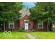 Charming brick home featuring a well-manicured lawn and mature trees at 3602 N Colorado Ave, Indianapolis, IN 46218