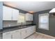 Bright kitchen with white cabinets, stainless steel sink, and modern backsplash at 3602 N Colorado Ave, Indianapolis, IN 46218