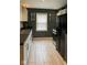 Stylish kitchen with stainless steel appliances, dark countertops, and light tile floors at 3602 N Colorado Ave, Indianapolis, IN 46218