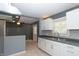 Bright kitchen featuring white cabinetry, modern fixtures, and neutral colored walls at 3602 N Colorado Ave, Indianapolis, IN 46218
