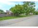 Street view of a residential area with a brick home and mature trees at 3602 N Colorado Ave, Indianapolis, IN 46218