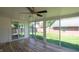 Bright sun room featuring walls of windows, wood-look floors, and a ceiling fan at 3602 N Colorado Ave, Indianapolis, IN 46218