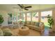Bright sunroom with neutral furniture, wicker accents, and ample windows bringing the outdoors in at 3602 N Colorado Ave, Indianapolis, IN 46218