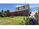 View of the backyard featuring a well-maintained lawn and a red deck at 404 Joseph Way, Carmel, IN 46032