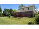View of the backyard featuring a well-maintained lawn and a red deck at 404 Joseph Way, Carmel, IN 46032
