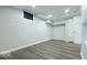 Finished room with recessed lights, painted walls and wood-look floors in the basement at 404 Joseph Way, Carmel, IN 46032