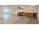 Finished basement with bar, built-in cabinets, window and open floorplan with light gray flooring at 404 Joseph Way, Carmel, IN 46032