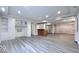 Bright basement featuring a bar with cabinets, built-ins, recessed lighting and wood-look flooring at 404 Joseph Way, Carmel, IN 46032
