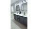 Bathroom with dual sinks, large mirrors, and a separate bathtub at 404 Joseph Way, Carmel, IN 46032