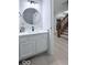 Powder bathroom with new vanity, mirror, and light fixture next to the staircase at 404 Joseph Way, Carmel, IN 46032