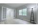 Bright bedroom with neutral paint, LVP flooring, and views from a large window at 404 Joseph Way, Carmel, IN 46032