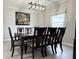 Traditional dining room featuring a modern chandelier and elegant dark wood furniture at 404 Joseph Way, Carmel, IN 46032