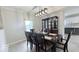 Charming dining room with a modern light fixture and a cabinet, next to the kitchen with white cabinets at 404 Joseph Way, Carmel, IN 46032