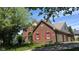 Charming brick home featuring a well-maintained lawn, red shutters and an attached garage at 404 Joseph Way, Carmel, IN 46032