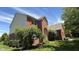Charming brick home featuring a well-maintained lawn, red shutters and a covered entry at 404 Joseph Way, Carmel, IN 46032