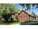 Charming brick home featuring a well-maintained lawn, red shutters and an attached garage at 404 Joseph Way, Carmel, IN 46032