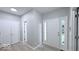 Inviting foyer with neutral paint, white trim, and LVP flooring, plus coat closets at 404 Joseph Way, Carmel, IN 46032