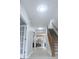 Hallway leads to the carpeted staircase and kitchen with an island at 404 Joseph Way, Carmel, IN 46032