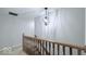 Hallway with wooden banister and modern chandelier at 404 Joseph Way, Carmel, IN 46032