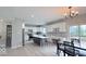 Bright kitchen with white cabinetry, a gray island, and a view of the deck at 404 Joseph Way, Carmel, IN 46032