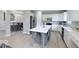 Stylish kitchen with white cabinets, gray island, and stainless steel appliances at 404 Joseph Way, Carmel, IN 46032