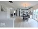 Open-concept kitchen with white cabinets, island, modern appliances, and easy access to the dining area at 404 Joseph Way, Carmel, IN 46032