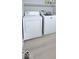 Bright laundry room with modern washer and dryer, and a convenient shelf for storage at 404 Joseph Way, Carmel, IN 46032