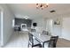 Open-concept living room with dining area, fireplace, and ample natural light at 404 Joseph Way, Carmel, IN 46032