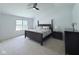 Well-lit main bedroom with ceiling fan, carpet floors, and a large window overlooking the outdoors at 404 Joseph Way, Carmel, IN 46032
