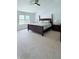 Spacious main bedroom featuring a ceiling fan, large windows, and plush carpeting at 404 Joseph Way, Carmel, IN 46032