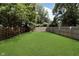 Large, level, fenced-in backyard featuring a lush green lawn at 4325 Norwaldo Ave, Indianapolis, IN 46205
