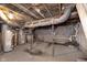 Unfinished basement with exposed ductwork, concrete floor, block walls, and old water heater at 4325 Norwaldo Ave, Indianapolis, IN 46205