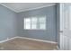 Bedroom featuring modern light-colored wood flooring, a window and a white door at 4325 Norwaldo Ave, Indianapolis, IN 46205