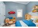 Bright bedroom with playful car decor, featuring unique shelving and a comfortable bed at 4325 Norwaldo Ave, Indianapolis, IN 46205