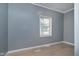 Bedroom featuring light-colored wood flooring, a window, baseboard trim, and grey paint at 4325 Norwaldo Ave, Indianapolis, IN 46205